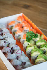 Stock photo of varied sushi box ready to deliver in japanese restaurant. - ADSF48861