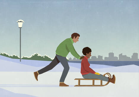 Boyfriend pushing girlfriend on sled in snowy winter city park - FSIF06623