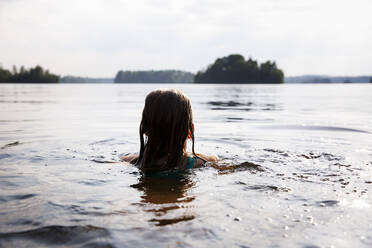 Girl swimming in Lake Nommen, Sweden - FOLF12388