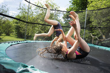 Happy girls playing on trampoline - FOLF12402