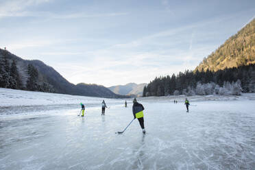 People playing ice hockey on frozen Lake Lodensee, Germany - FOLF12436