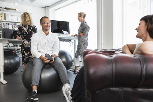 Colleagues talking during office meeting - FOLF12537