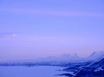 Snow on Lapporten Mountain and Tornetrask Lake at sunset in Sweden - FOLF12568