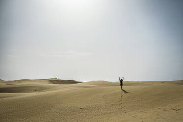 Man walking on sand dunes during sunset - FOLF12617