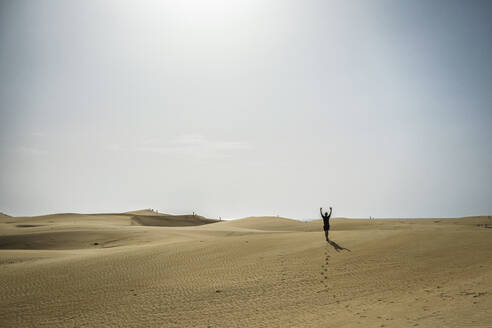 Man walking on sand dunes during sunset - FOLF12617