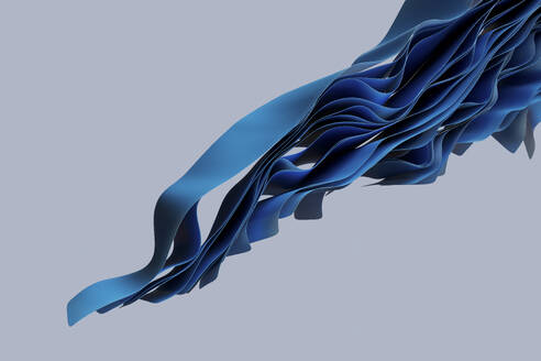 Gewellte blaue Textilien fließen vor grauem Hintergrund - GCAF00485