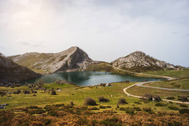 Photo of a serene lake nestled among towering mountains. Covadonga lake, Spain - ADSF49101