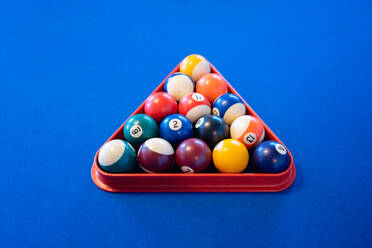 High angle of colorful pyramid of billiard balls in billiard triangle on blue pool table - ADSF49158