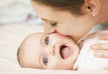 Close up of Mother Kissing Baby - FSIF06697