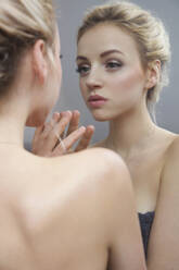 Young Woman Looking in Mirror - FSIF06707