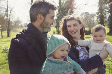 Family in Park Holding Baby Twins - FSIF06709