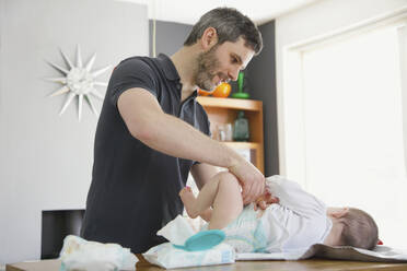 Father Changing Baby Girl Diaper - FSIF06712