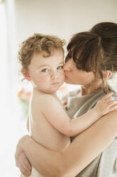 Mother Holding and Kissing Baby Son - FSIF06723