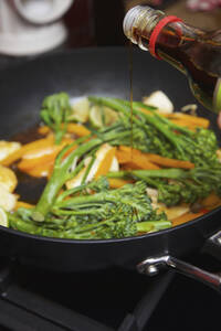 Adding Soy Sauce to Vegetable Stir Fry - FSIF06748
