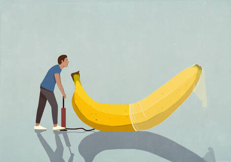 Man with bicycle pump inflating condom on banana - FSIF06766