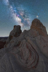 Breathtaking view of arid hills and mountains located against starry sky at dark night in Utah USA - ADSF49209