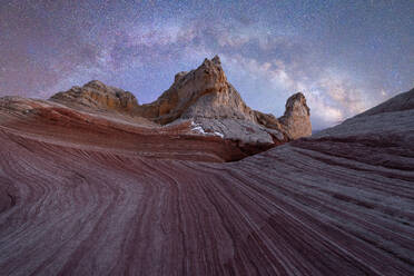 Breathtaking view of arid hills and mountains located against starry sky at dark night in Utah USA - ADSF49214