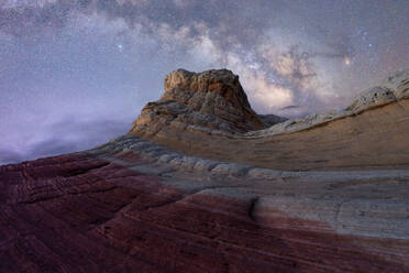 Breathtaking view of arid hills and mountains located against starry sky at dark night in Utah USA - ADSF49216