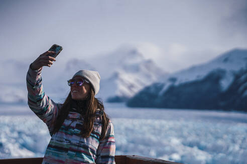 Woman taking selfie at Los Glaciares National Park in Argentina - RSGF00971