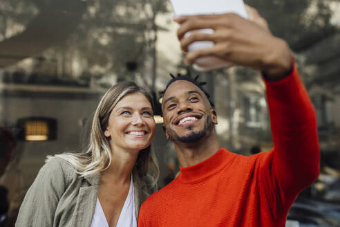 Happy business colleagues taking selfie through tablet PC - JOSEF22115