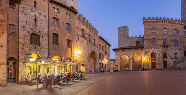 View of restaurants in Piazza del Duomo at dusk, San Gimignano, UNESCO World Heritage Site, Province of Siena, Tuscany, Italy, Europe - RHPLF28984