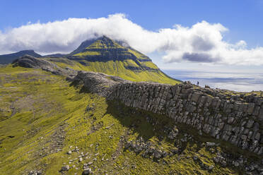 One person hikes the ridge toward the Skaelingsfjall mountain, Streymoy island, Faroe islands, Denmark, Europe - RHPLF29072