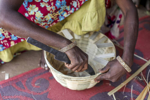 Adivasi woman making baskets in a village in Narmada district, Gujarat, India, Asia - RHPLF29170