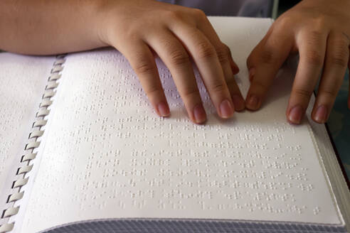 Close up on hands of blind girl reading braille book, Center for Blind Children, Ho Chi Minh City, Vietnam, Indochina, Southeast Asia, Asia - RHPLF29199
