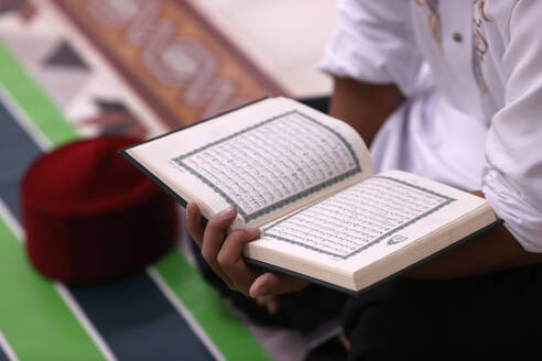 Muslim man reading a Quran, Ho Chi Minh City, Vietnam, Indochina, Southeast Asia, Asia - RHPLF29238