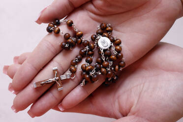 Woman's hands holding wood Catholic rosary in prayer, Vietnam, Indochina, Southeast Asia, Asia - RHPLF29244