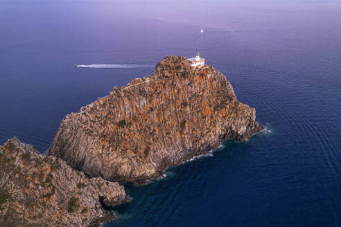 High angle view of the lighthouse of Ponza (Punta della Guardia lighthouse) on top of basalt cliff at dusk, Ponza island, Tyrrhenian Sea, Pontine islands, Latina Province, Latium (Lazio), Italy, Europe - RHPLF29402