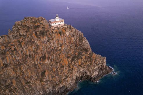 Punta della Guardia basalt cliff with the lighthouse at dusk, Ponza island, Tyrrhenian Sea, Pontine islands, Latina Province, Latium (Lazio), Italy, Europe - RHPLF29404