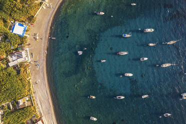 Aerial view of Palmarola bay with boats anchored in turquoise water at susnet, Palmarola island, Ponza municipality, Tyrrhenian sea, Pontine archipelago, Latina Province, Latium (Lazio), Italy, Europe - RHPLF29412