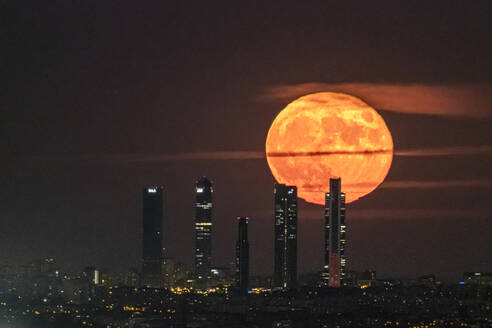 The Blue Moon, full moon at perigee, behind the Cuatro Torres skyscrapers in Madrid, Spain, Europe - RHPLF29636