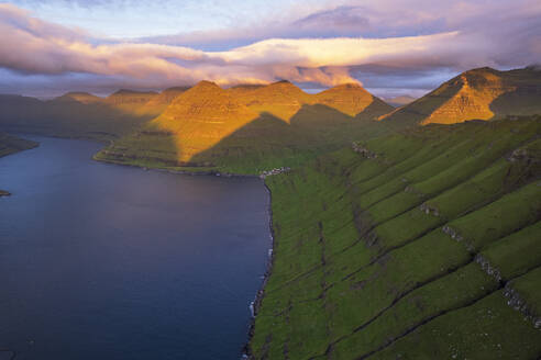 Aerial shot of the dramatic view of Funningur with pink sky at dawn, Eysturoy island, Faroe islands, Denmark, Europe - RHPLF29847