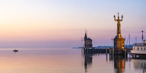 Germany, Baden-Wurttemberg, Konstanz, Harbor on shore of Bodensee at dawn with Imperia statue in foreground - WDF07456