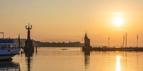 Germany, Baden-Wurttemberg, Konstanz, Panoramic view of harbor on shore of Bodensee at sunrise - WDF07460