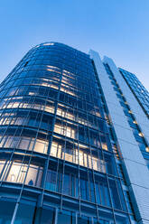 Germany, Baden-Wurttemberg, Stuttgart, Exterior of tall office building at dusk - WDF07463