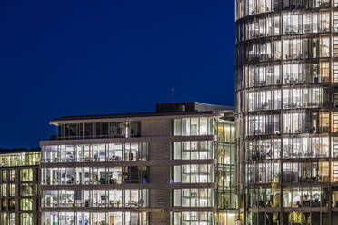 Germany, Baden-Wurttemberg, Stuttgart, Illuminated office buildings at night - WDF07464