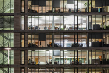 Germany, Baden-Wurttemberg, Stuttgart, Exterior of illuminated office building at night - WDF07466