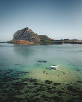 Luftaufnahme eines Wasserflugzeugs, das in einer Lagune mit Barriereriff landet, mit dem Berg Le Morne im Hintergrund, Le Morne Brabant, Riviere Noire, Mauritius. - AAEF24650