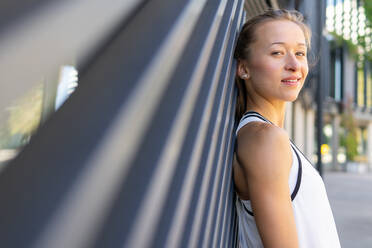 Photo of a Active Woman Captured in a White Tank Top Striking a Pose - ADSF49572