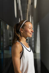 Photo of a Active Woman Captured in a White Tank Top Striking a Pose - ADSF49577