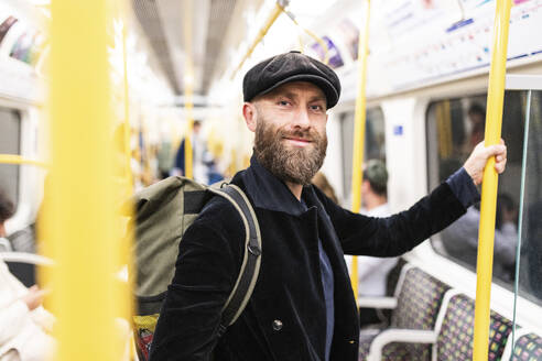 Smiling mature man traveling in train - WPEF07879