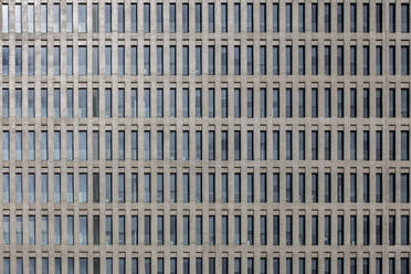 High multistory business buildings with rows of symmetric geometric windows located in downtown of megalopolis - ADSF49866