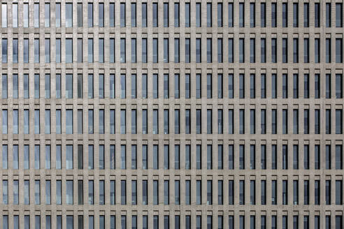 High multistory business buildings with rows of symmetric geometric windows located in downtown of megalopolis - ADSF49866