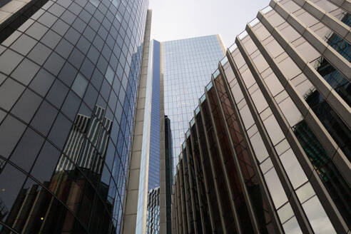 Low-angle view of modern glass skyscrapers stretching towards the sky in London's bustling cityscape. - ADSF49967