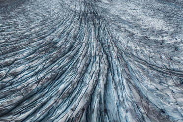 From above drone image of picturesque scenery of massive glacier surface with blue ice located in Vatnajokull National park in Iceland - ADSF49985