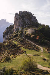 Young woman walking near mountain on sunny day - RSGF00986