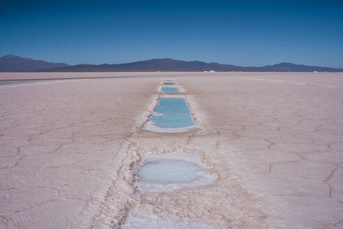 Lake near salt flats under blue sky - RSGF01001